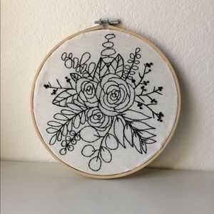 Hand embroidered black floral wall art.